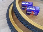 Pair Of Duro 26X2.10 Gum Wall Mountain Bicycle Tires With Two Inner Tubes. Fixed Price $37.99.